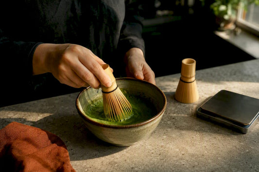 Home brewer whisking matcha beside precision scale